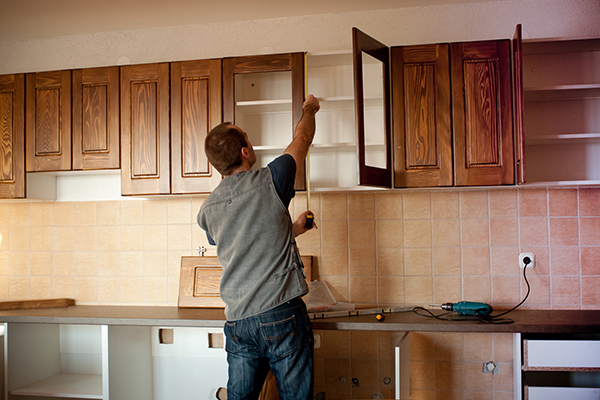 An image showing a joiner fitting a kitchen